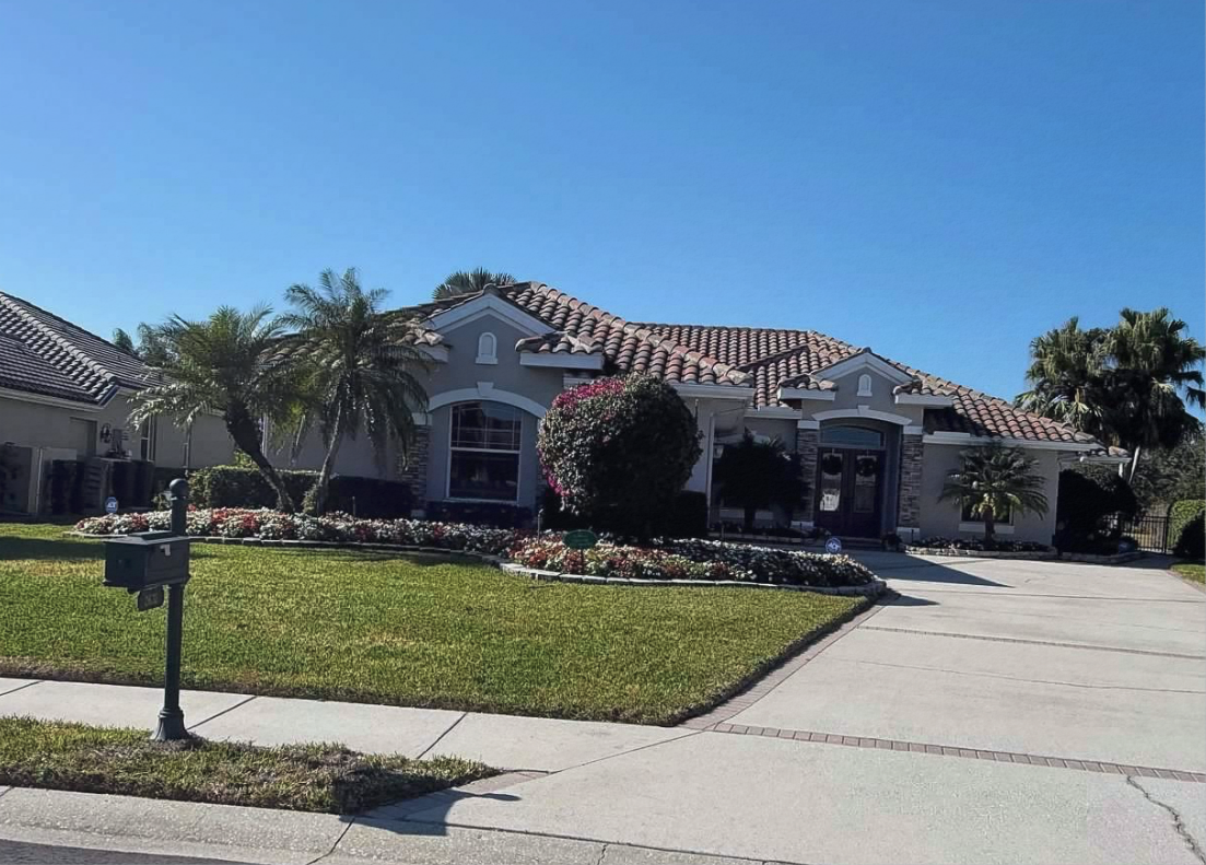 Yard of the Month in River Wilderness WINNERS -  January 2026 - featuring a beautiful well kept yard showcasing vibrant red and white impatiens that add a cheerful pop of color and welcoming charm to the street.
